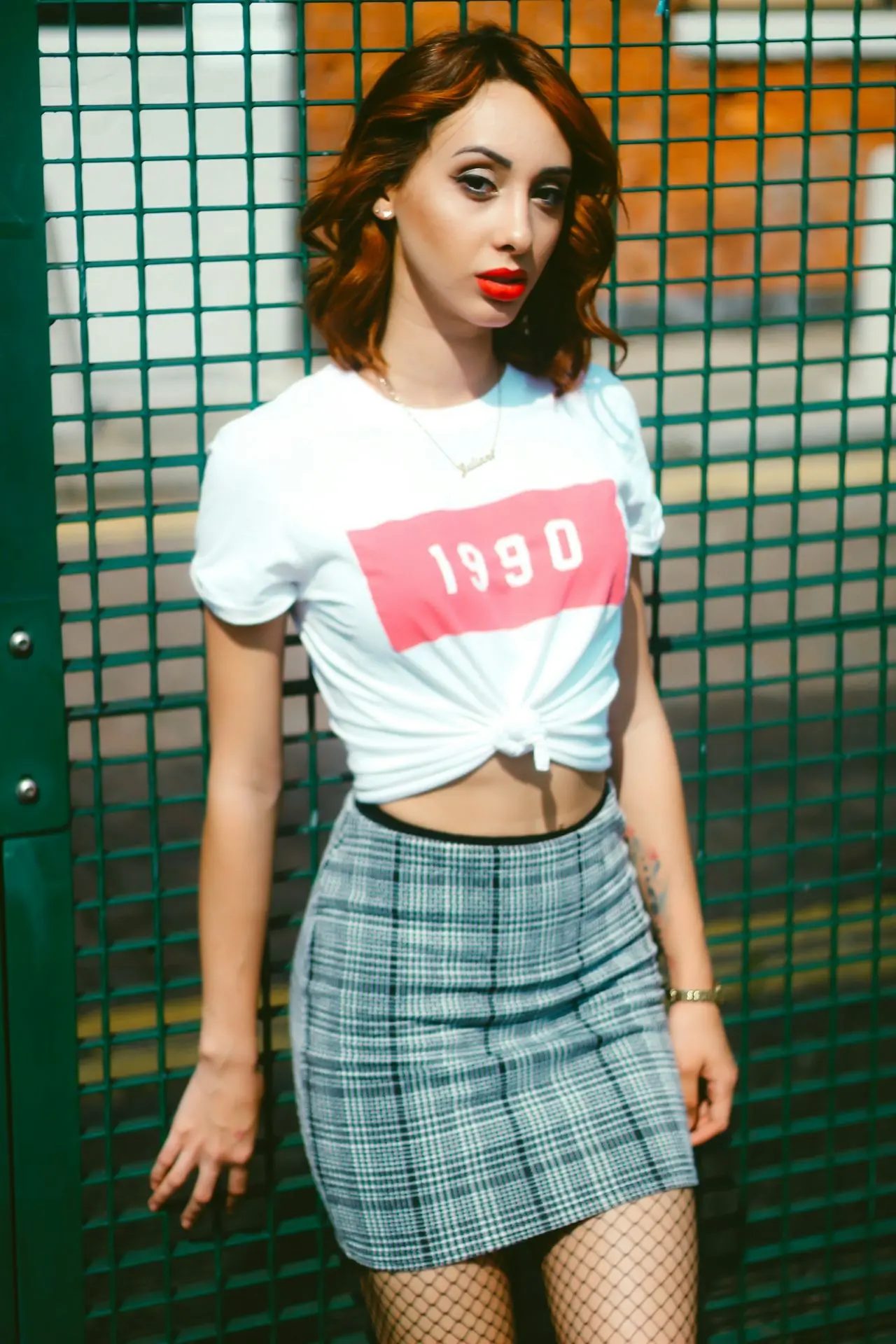 woman in white and red crew neck t-shirt and blue and white plaid skirt